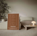 Minimalist basketball court digital art print in warm brown tones leaning on a sofa in a modern living room, printable wall art set — Haus of Prints.