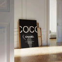 Parisian Statement print leaning against a wall, showcasing its striking black backdrop and simple typography.