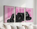 Black KAWS figurine poster with pink background, featuring the word "KAWS" in bold letters, modern home decor.