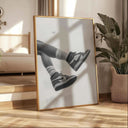 Black and white sneaker poster design displayed in a bright interior, showcasing originality.