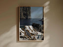 Artistic view of a serene outdoor setting with striped lounge chairs by the sea, evoking relaxation.