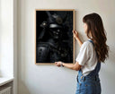 Woman adjusting the Shadow Honor II – Black Samurai Art Print in a cozy room, showcasing the stunning artwork.