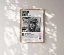 Close-up of Taylor Swift poster, showcasing her expression and signature in elegant black and white.