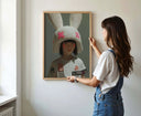 Woman holding the Urban Bunny Muse Surreal Fashion Art Print in a minimalist setting, emphasizing its design.