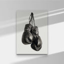 Vintage Boxing Gloves Wall Art featuring two black gloves hanging, perfect for modern decor in any space.