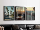 Vintage Cityscape Poster Set of 3 featuring framed digital wall art with palm trees and sunset views above a black sofa, modern living room décor, Haus of Prints.