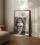 Vintage-style Joker movie poster displaying Joaquin Phoenix's character with damaged makeup and a bold red smile.