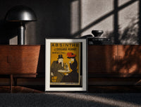 Black-framed Man and woman drinking absinthe at table print on a moody console with designer coffee-table books