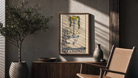 Ace of Swords poster framed above a fluted sideboard beside a potted tree