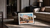 London Admiralty Arch and street scene print in a slim black frame leaning on a travertine coffee table