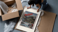 Alpine mountain and lake landscape framed print being unpacked from protective bubble wrap and a box