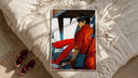 Red Akira Kaneda Jacket framed print styled on a bed with sneakers alongside