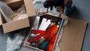 Red Akira Kaneda Jacket framed print being unboxed from protective packaging