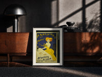 Black-framed Woman in yellow eating biscuit print on a moody console with designer coffee-table books