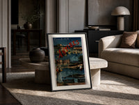 Antibes coastal town scene print in a black frame leaning on a travertine table in a sunlit lounge