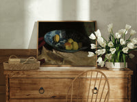 Apples and lemon in blue bowl print in an oak frame on a farmhouse dresser beside white tulips