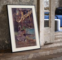 Two children resting in forest print in a black frame leaning beside a vintage door on parquet