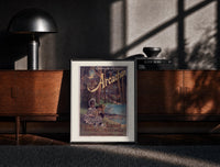 Black-framed two children resting in forest print on a moody console with designer coffee-table books