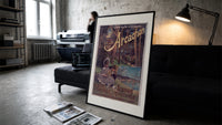 Two children resting in forest print in a slim black frame leaning on a dark sofa in a concrete print studio