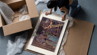 Two children resting in forest framed print being unpacked from protective bubble wrap and a box
