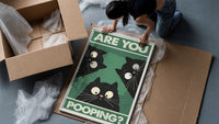 Are You Pooping Three Cats framed print being unpacked from protective bubble wrap and a box