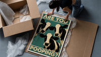 Are You Pooping Three Cows framed print being unpacked from protective bubble wrap and a box