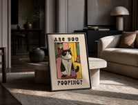 Are You Pooping Tuxedo Cat print on the floor, leaning against a travertine table