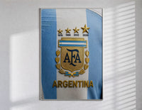 Argentina football national team crest jersey poster in a slim frame on a bright wall with soft window light