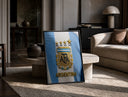 Argentina football national team crest jersey print in a black frame leaning on a travertine table in a sunlit lounge