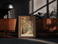 Black-framed Bob Cratchit and boys sliding on street print on a moody console with designer coffee-table books