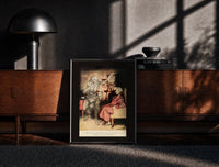 Black-framed Ghost of Marley visiting Scrooge print on a moody console with designer coffee-table books