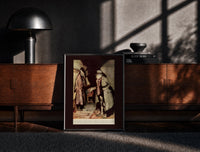 Black-framed Old man in nightgown examining dressing-gown print on a moody console with designer coffee-table books
