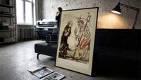 Devil with pitchfork and old man print in a slim black frame leaning on a dark sofa in a concrete print studio