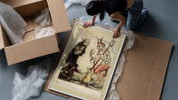 Devil with pitchfork and old man framed print being unpacked from protective bubble wrap and a box