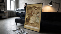 Victorian couples dancing at party print in a slim black frame leaning on a dark sofa in a concrete print studio