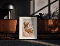 Black-framed Santa Claus in reindeer-drawn sleigh print on a moody console with designer coffee-table books