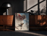 Black-framed anime soldier battling colossal titan print on a moody console with designer coffee-table books