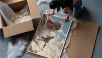 anime soldier battling colossal titan framed print being unpacked from protective bubble wrap and a box