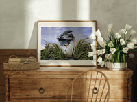 Great blue heron in marsh print in an oak frame on a farmhouse dresser beside white tulips