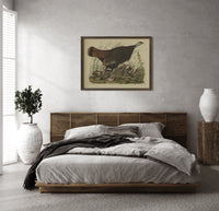Female wild turkey with chicks print in a dark wood frame above a rattan bed on a plaster wall