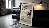 Woman in bathing suit at beach print in a slim black frame leaning on a dark sofa in a concrete print studio