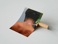 Gently curled Back View Fastening a Necklace print beside its protective shipping tube