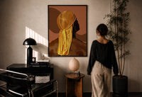 Back View in a Gold Durag print in a black frame on a sunlit plaster wall, a woman looking on beside a mushroom lamp