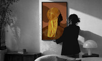 Back View in a Gold Durag print in a slim black frame being hung on a sunlit wall in a monochrome room
