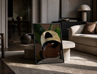 Backwards Cap with an Embracing Hand print on the floor, leaning against a travertine table
