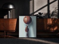 Black-framed Basketball Balanced on a Fingertip print on the floor in front of a dark wooden console