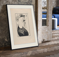 Two elegant women in flowing gowns print in a black frame leaning beside a vintage door on parquet