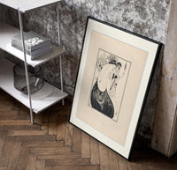 Two elegant women in flowing gowns poster in a black frame leaning beside a shelf in a raw-plaster loft