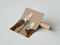 Gently curled Beige Sneakers and White Socks print beside its protective shipping tube