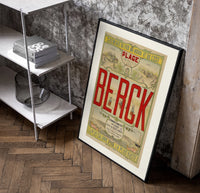 Berck beach seaside resort advertisement poster in a black frame leaning beside a shelf in a raw-plaster loft